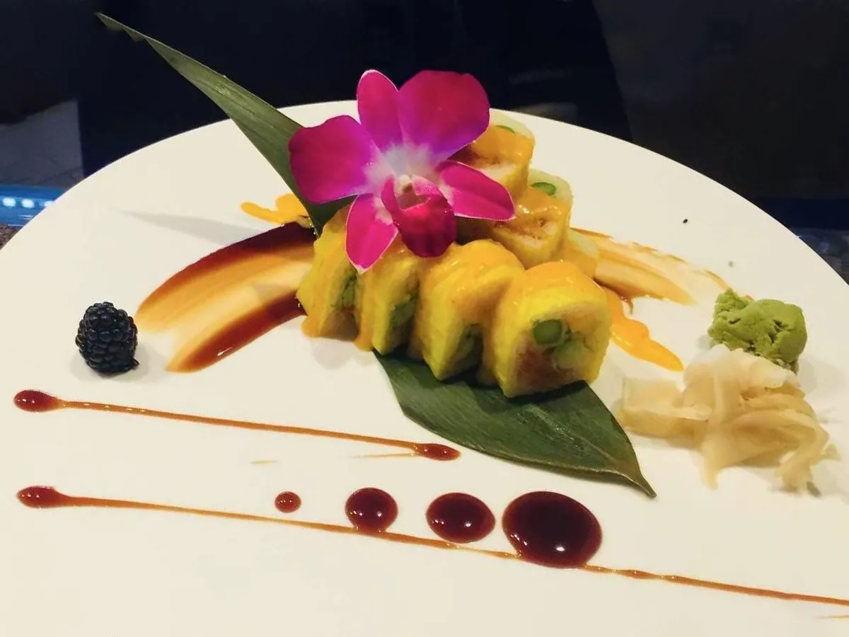 Artfully plated sushi roll with orchid garnish at Extreme Japanese Restaurant in DuBois
